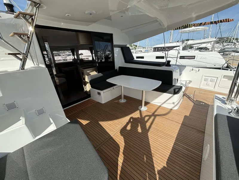 Slide: The Image of 2025 Lagoon 42 yacht with spacious deck and seating area. - 3