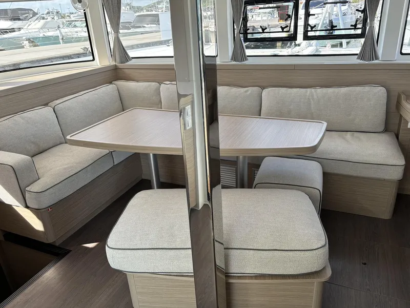Slide: The Image of Interior of 2025 Lagoon 42 catamaran with cozy seating and dining area. - 6