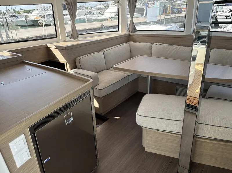 Slide: The Image of Interior of 2025 Lagoon 42 catamaran with modern seating and dining area. - 7