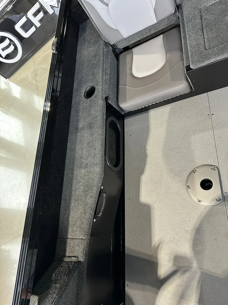 Slide: The Image of Interior view of 2025 Smoker Craft Adventurer 188 DC boat, featuring seating and flooring. - 11