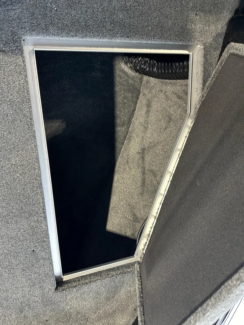 Slide: The Image of 2025 Smoker Craft Adventurer 188 DC boat storage compartment with open hatch. - 12