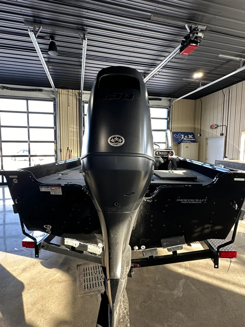 Slide: The Image of 2025 Smoker Craft Adventurer 188 DC boat in a garage, rear view. - 15