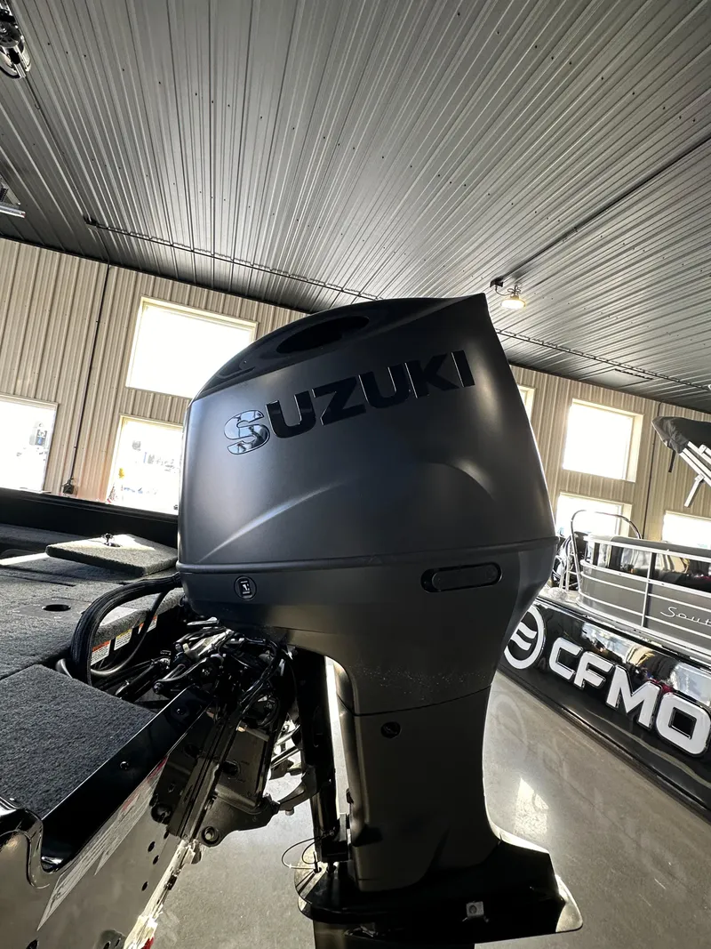 Slide: The Image of 2025 Smoker Craft Adventurer 188 DC with Suzuki outboard motor in showroom. - 16