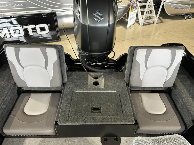 Slide: The Image of 2025 Smoker Craft Adventurer 188 DC boat interior with dual seats and motor. - 4