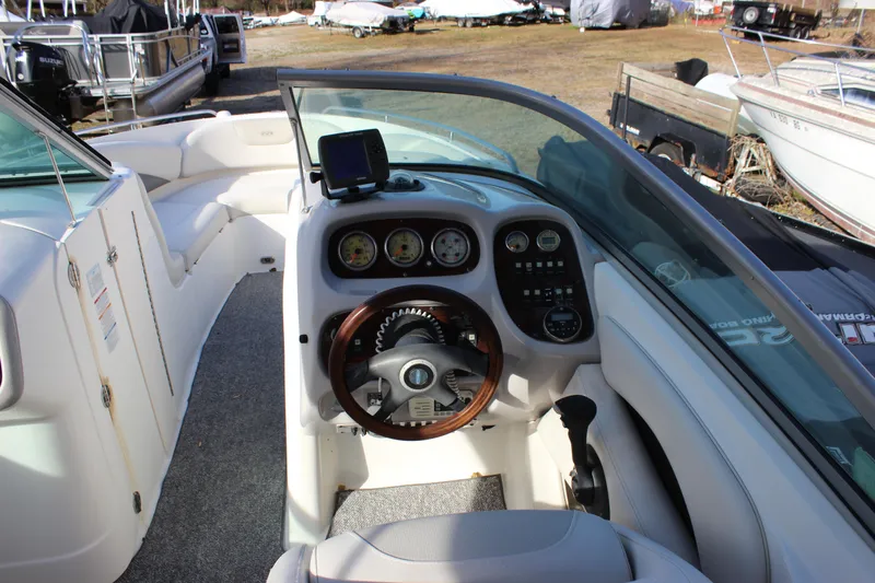 Slide: The Image of 2006 Chaparral 256 SSi boat cockpit with steering wheel and dashboard controls. - 17