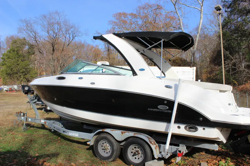 Slide: The Image of 2006 Chaparral 256 SSi boat on trailer, parked outdoors. - 2
