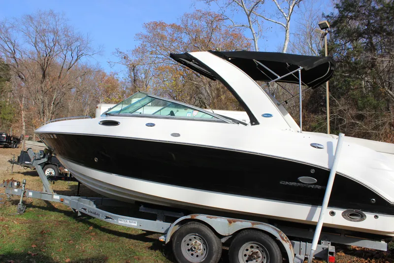 Slide: The Image of 2006 Chaparral 256 SSi boat on trailer, black and white design, parked outdoors. - 3