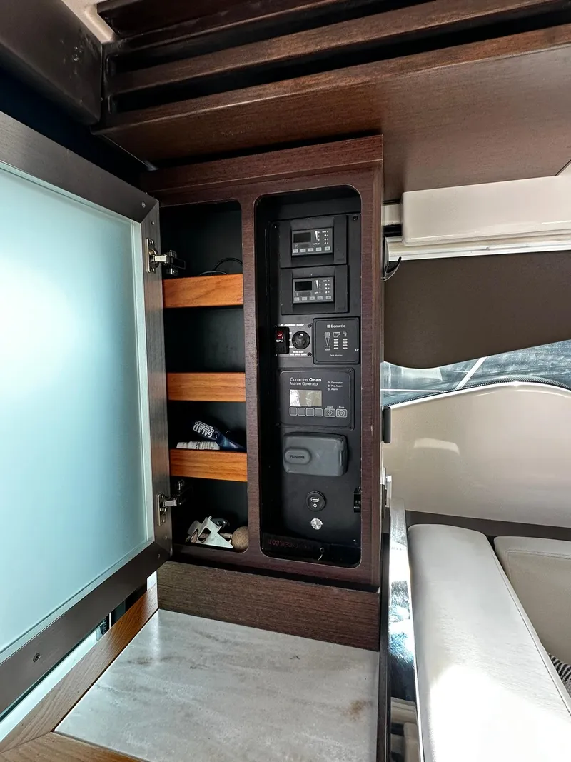 Slide: The Image of Control panel inside 2016 Tiara Yachts 49 COUPE, featuring modern wood cabinetry. - 15