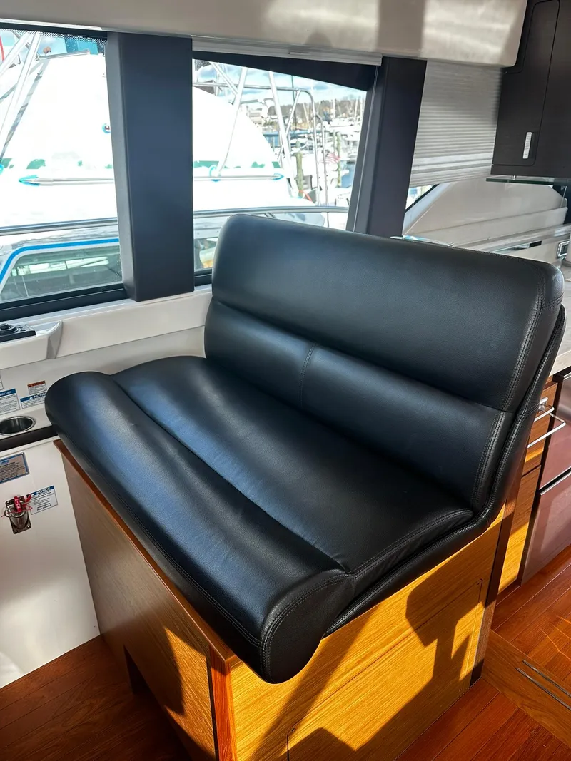 Slide: The Image of Luxurious black leather seat in 2016 Tiara Yachts 49 COUPE interior. - 18