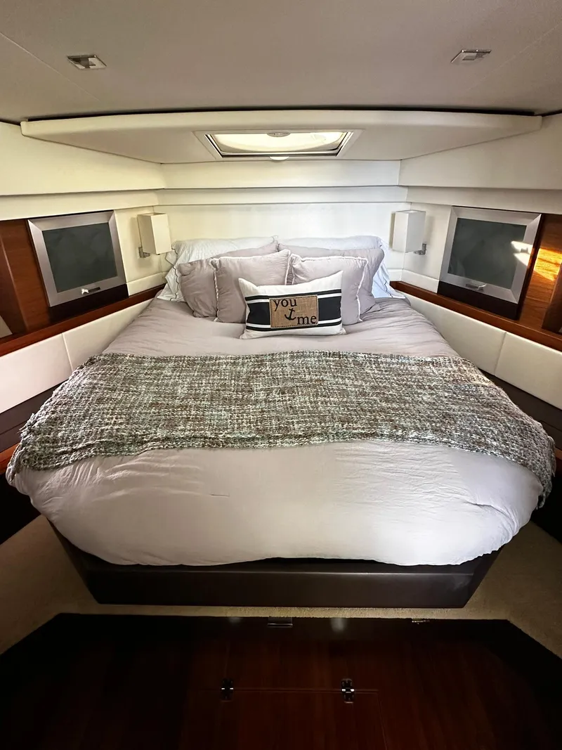 Slide: The Image of Luxurious bedroom in 2016 Tiara Yachts 49 COUPE with plush bedding and elegant decor. - 22