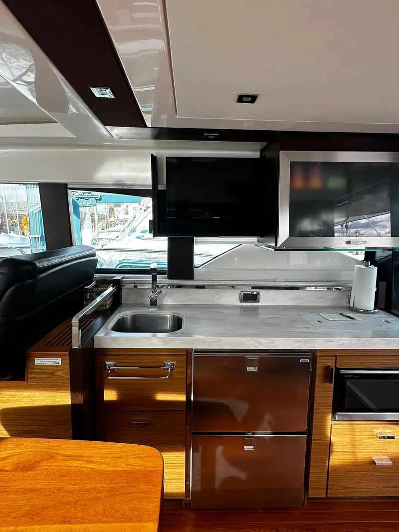 Slide: The Image of Interior of 2016 Tiara Yachts 49 COUPE with modern kitchen and sleek design. - 27