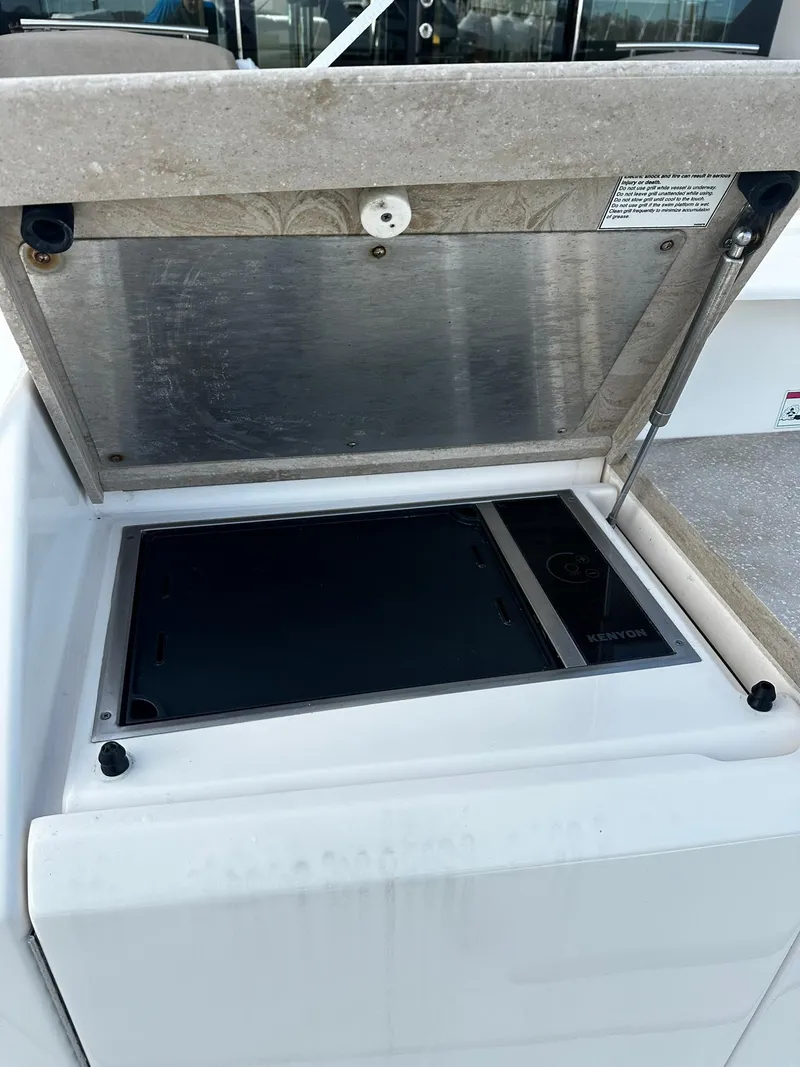 Slide: The Image of 2016 Tiara Yachts 49 COUPE outdoor kitchen with closed grill lid. - 3