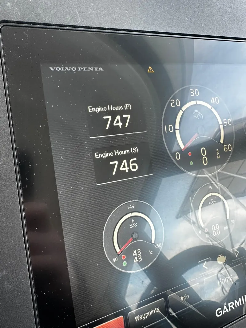 Slide: The Image of 2016 Tiara Yachts 49 COUPE dashboard displaying engine hours and gauges. - 35