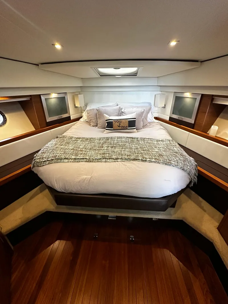 Slide: The Image of Luxurious bedroom interior of 2016 Tiara Yachts 49 COUPE with elegant bedding and wood accents. - 36