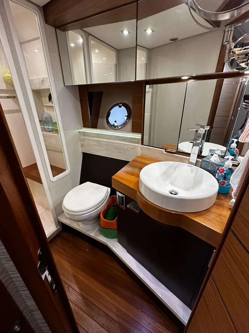 Slide: The Image of Luxurious bathroom in 2016 Tiara Yachts 49 COUPE with modern fixtures and wood accents. - 38