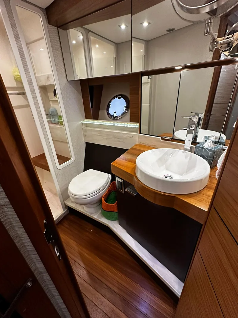 Slide: The Image of Luxurious 2016 Tiara Yachts 49 COUPE bathroom with modern fixtures and wood accents. - 39
