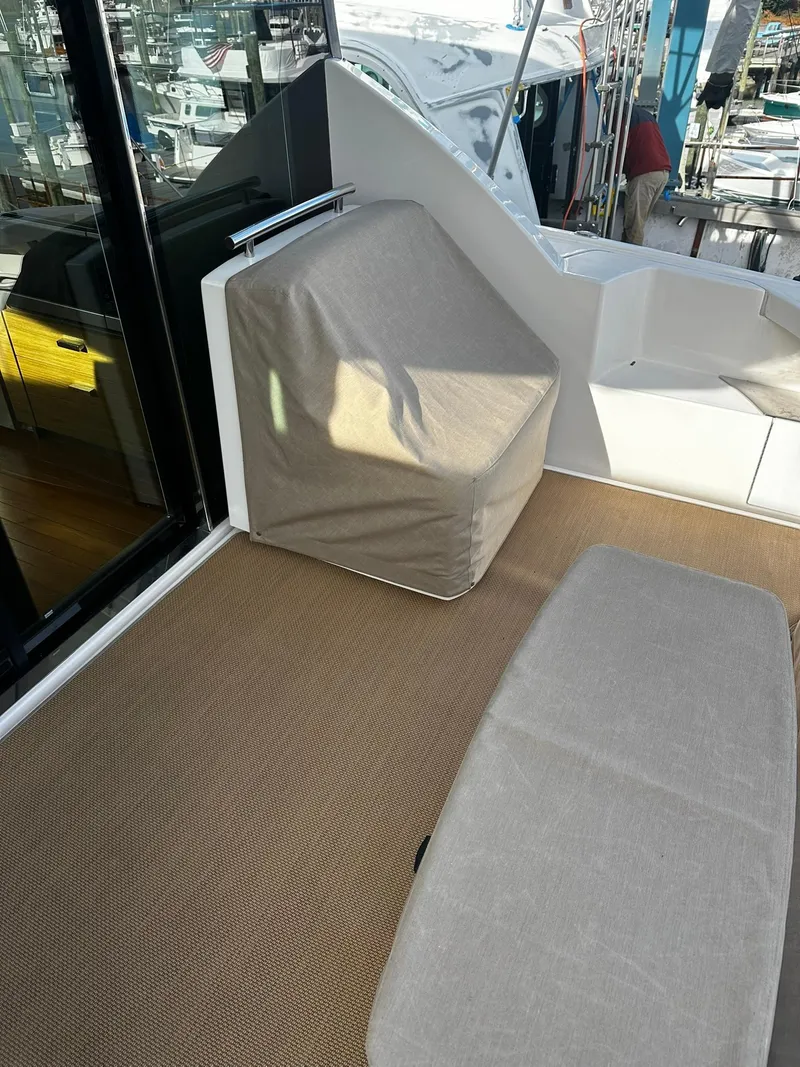 Slide: The Image of 2016 Tiara Yachts 49 COUPE deck with covered seating area. - 4