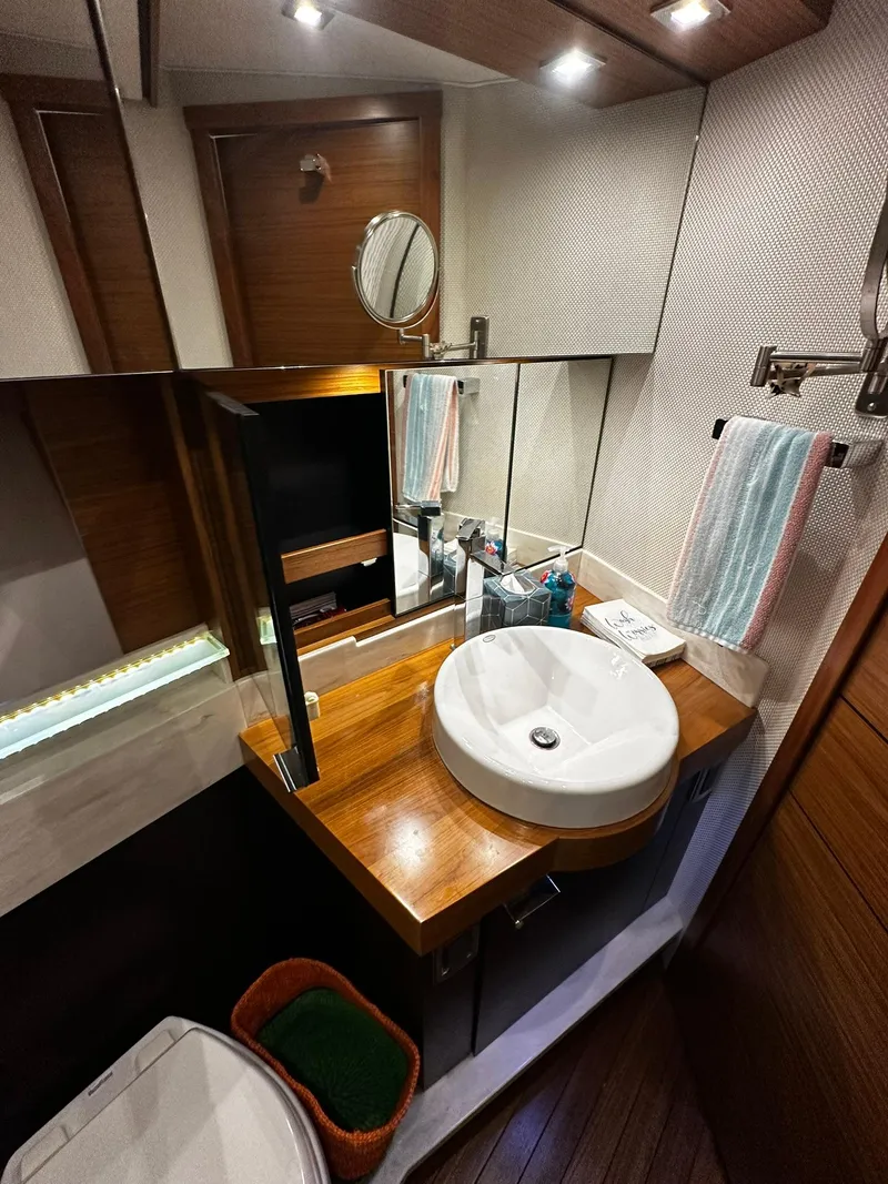 Slide: The Image of Luxurious bathroom in 2016 Tiara Yachts 49 COUPE with modern fixtures and wood accents. - 40