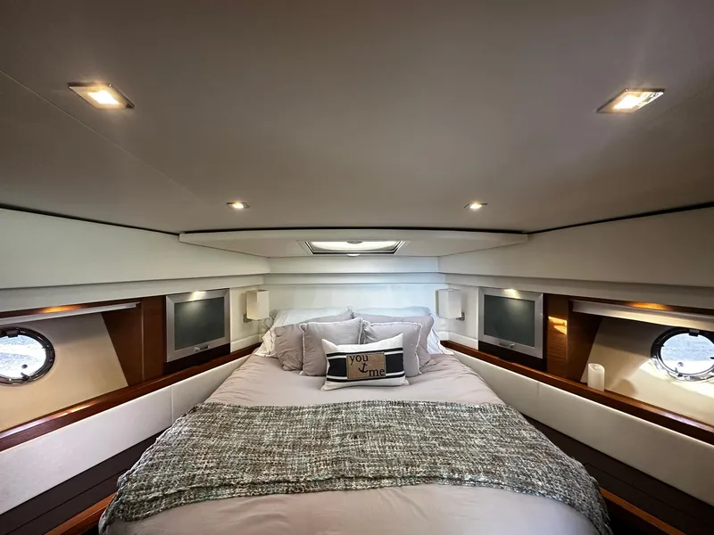 Slide: The Image of Luxurious bedroom interior of 2016 Tiara Yachts 49 COUPE with elegant bedding and ambient lighting. - 44
