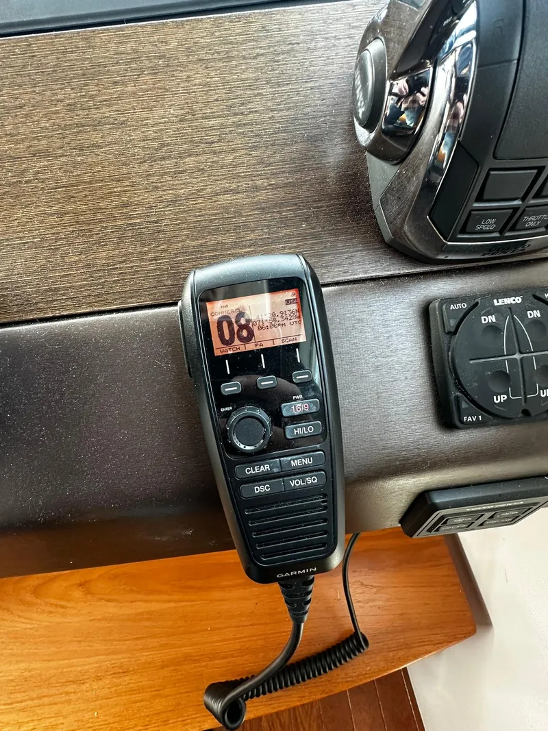 Slide: The Image of 2016 Tiara Yachts 49 COUPE dashboard with marine radio and controls. - 46