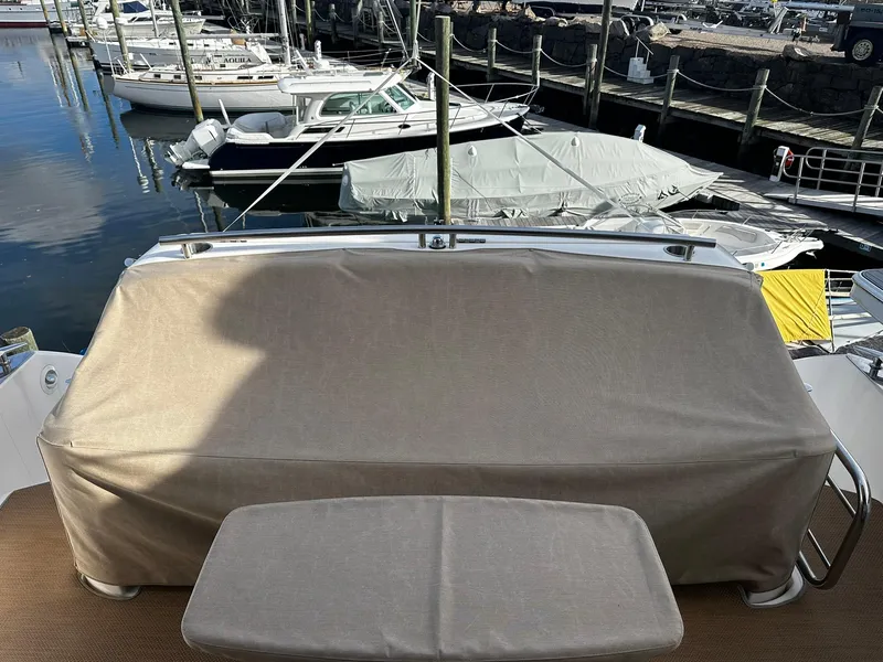 Slide: The Image of 2016 Tiara Yachts 49 COUPE with covered seating area at marina. - 5