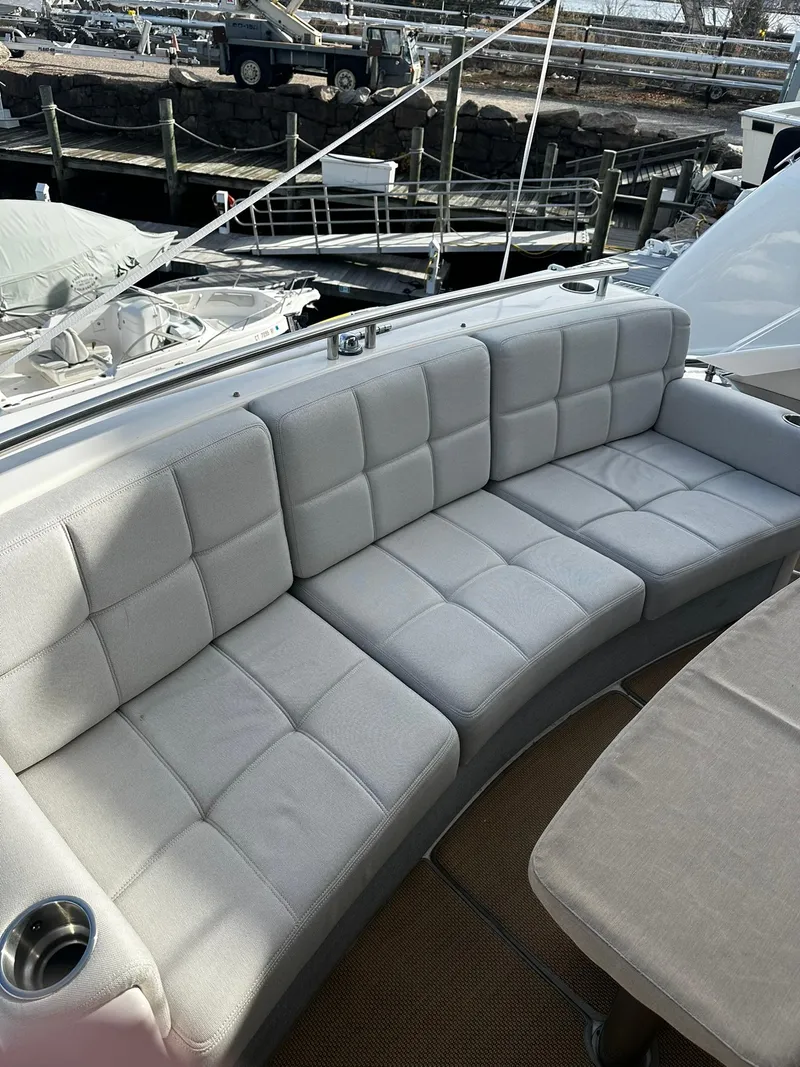 Slide: The Image of Luxurious seating on 2016 Tiara Yachts 49 COUPE, featuring plush white cushions. - 8
