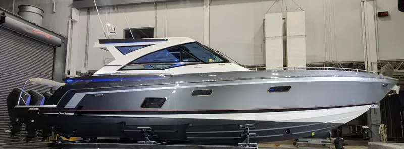 Slide: The Image of 2021 Formula 430 Super Sport Crossover boat in a showroom setting. - 20