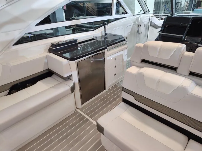 Slide: The Image of 2021 Formula 430 Super Sport Crossover interior with seating and kitchenette. - 27