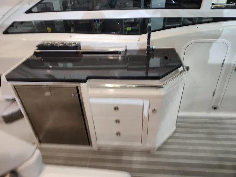Slide: The Image of 2021 Formula 430 Super Sport Crossover yacht kitchenette with sleek countertop and modern appliances. - 29