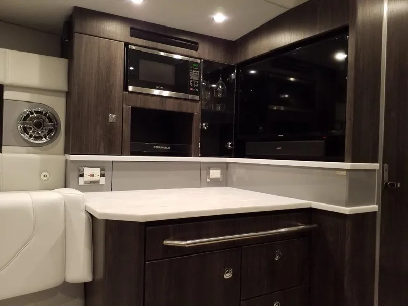 Slide: The Image of 2021 Formula 430 Super Sport Crossover interior with modern kitchen amenities. - 3