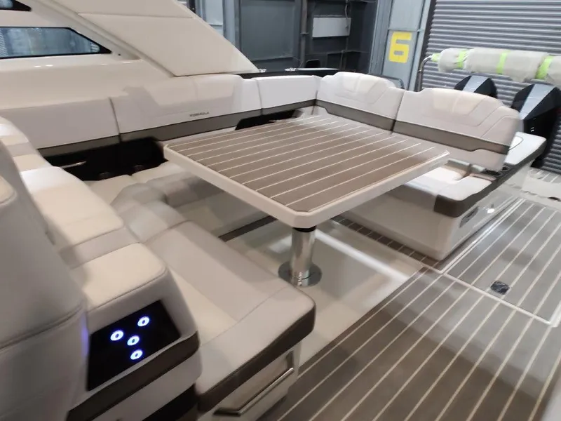Slide: The Image of 2021 Formula 430 Super Sport Crossover yacht interior with sleek seating and table. - 34