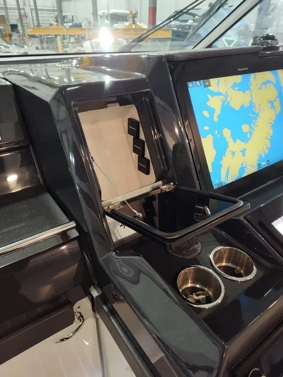 Slide: The Image of 2021 Formula 430 Super Sport Crossover dashboard with navigation screen and cup holders. - 40