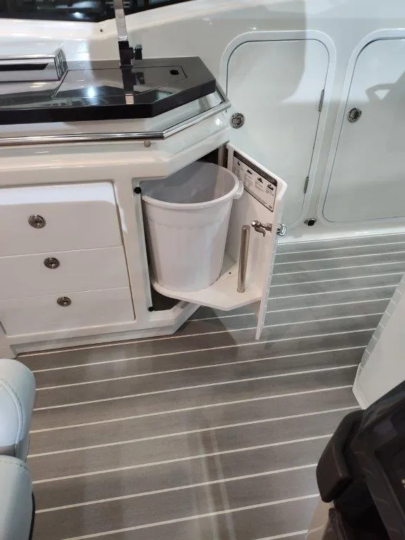 Slide: The Image of 2021 Formula 430 Super Sport Crossover interior with pull-out trash bin and sleek cabinetry. - 42