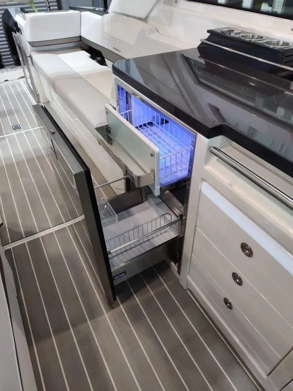 Slide: The Image of 2021 Formula 430 Super Sport Crossover interior with open drawer fridge, sleek design. - 43