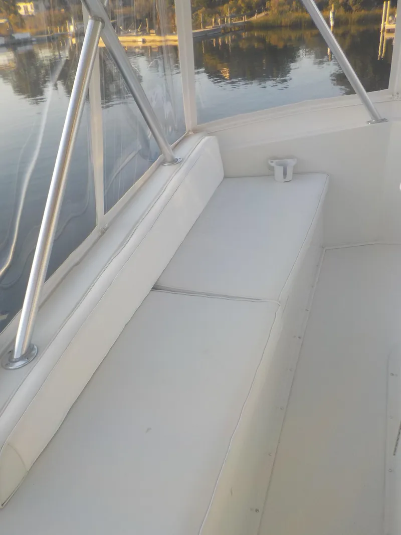 Slide: The Image of 1996 Viking 47 Convertible boat interior with white seating and railing. - 18