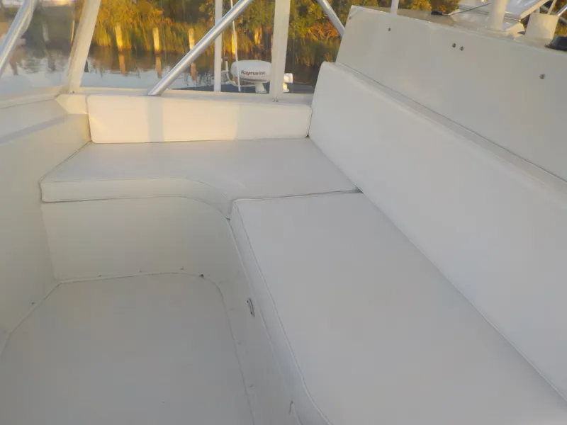 Slide: The Image of 1996 Viking 47 Convertible boat seating area, white upholstery, outdoor setting. - 19