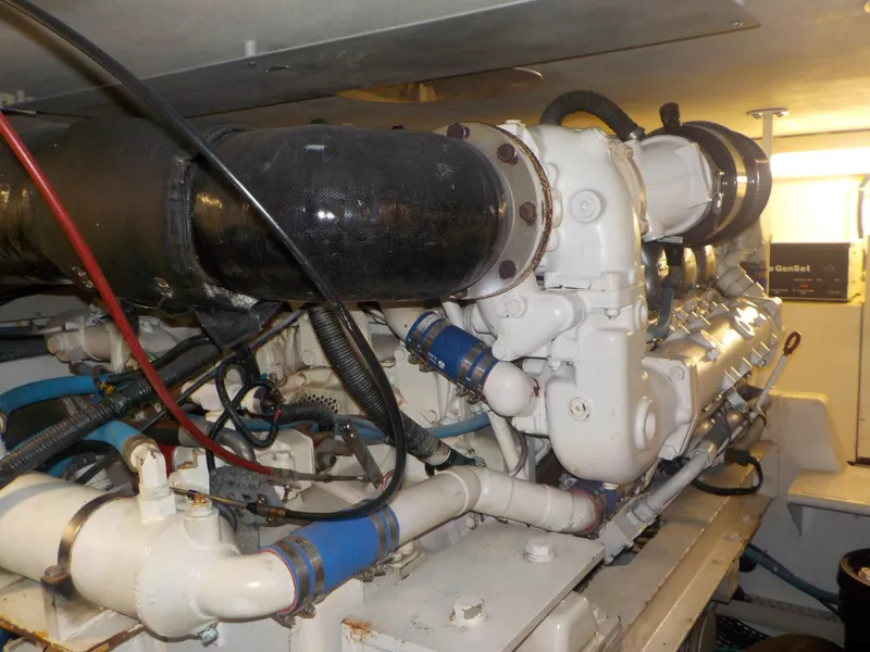 Slide: The Image of Engine room of 1996 Viking 47 Convertible yacht, showcasing complex machinery and piping. - 27
