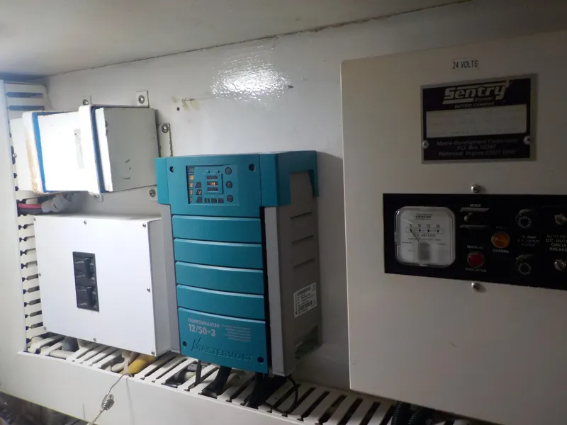 Slide: The Image of Electrical panel inside 1996 Viking 47 Convertible boat, featuring various control units. - 29
