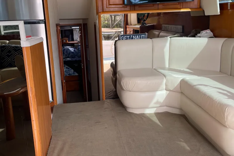 Slide: The Image of Interior of 1996 Viking 47 Convertible yacht with white leather seating and wood accents. - 6