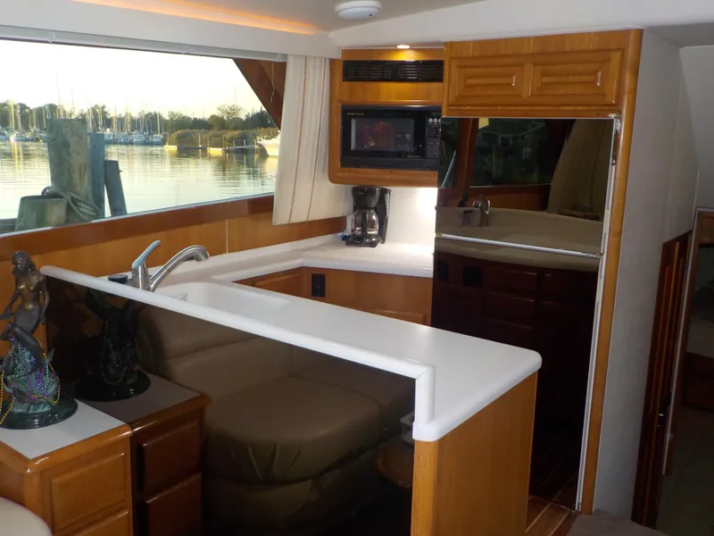 Slide: The Image of Interior of 1996 Viking 47 Convertible yacht with modern kitchen and scenic window view. - 8