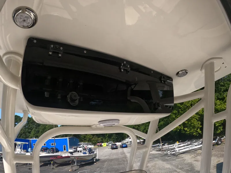 Slide: The Image of 2025 Key West 239 FS boat console with black panel, parked in a lot. - 11