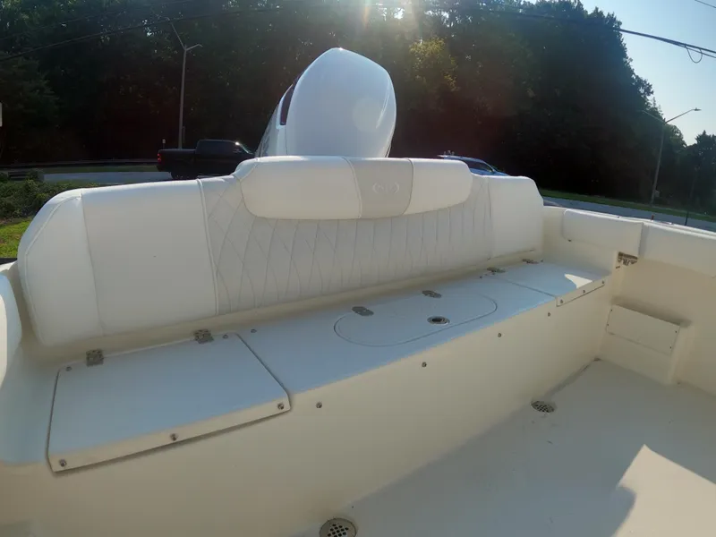 Slide: The Image of 2025 Key West 239 FS boat interior with white seating and storage compartments. - 12