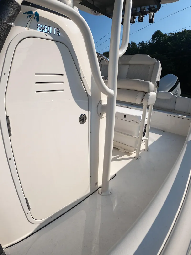 Slide: The Image of 2025 Key West 239 FS boat interior with seating and storage compartment. - 22