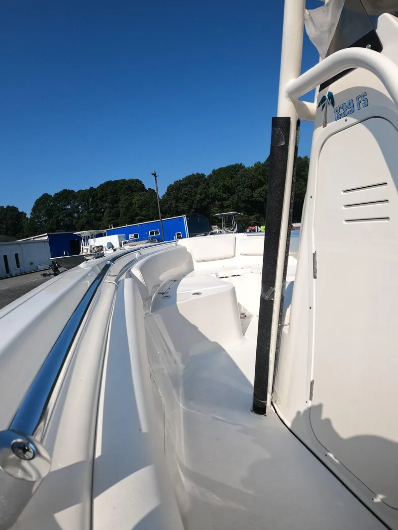 Slide: The Image of 2025 Key West 239 FS boat, white exterior, docked under clear blue sky. - 23