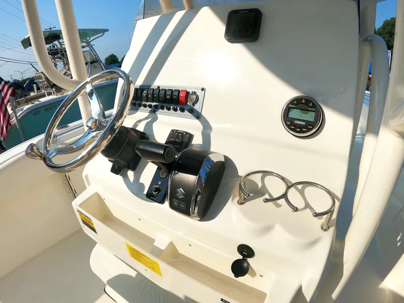Slide: The Image of 2025 Key West 239 FS boat dashboard with steering wheel and controls. - 9