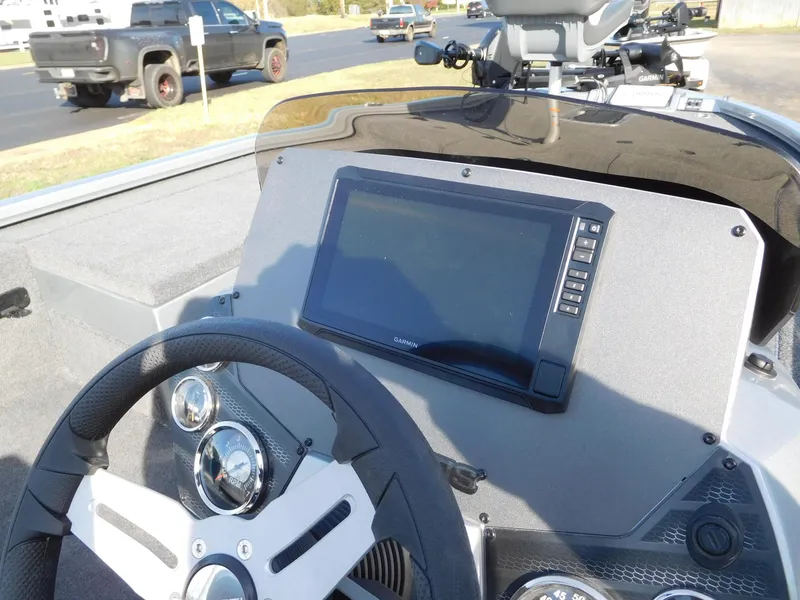 Slide: The Image of 2025 Vexus AVX 1980C boat dashboard with steering wheel and digital display. - 2