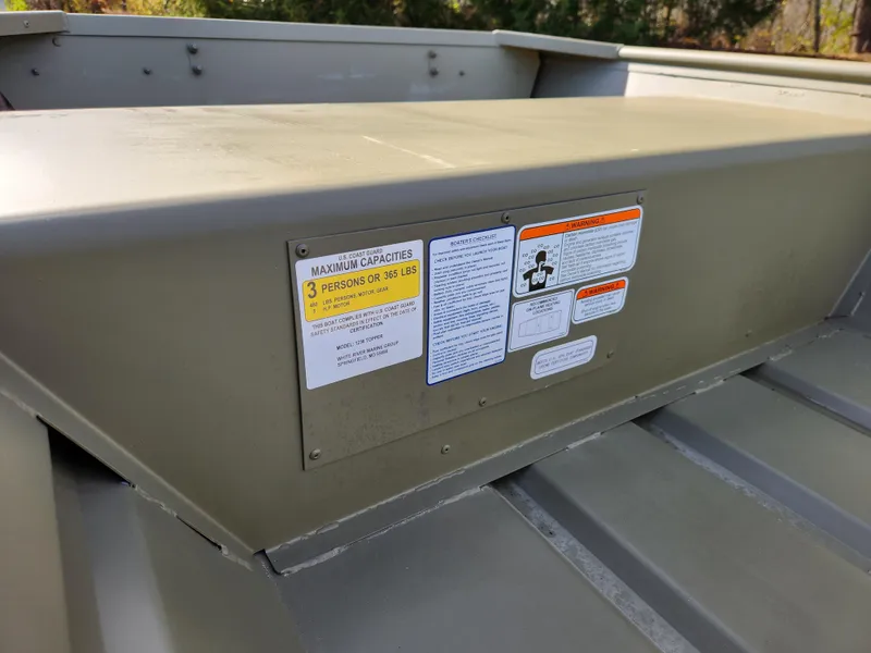 Slide: The Image of 2025 Tracker Grizzly 1236 Utility boat with capacity and safety labels. - 4