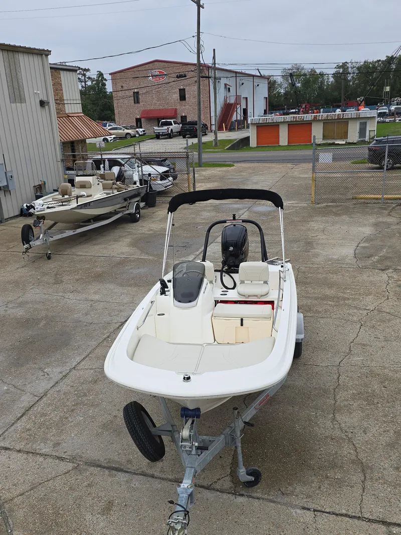 Slide: The Image of 2022 Boston Whaler 160 Super Sport boat in a parking lot. - 10