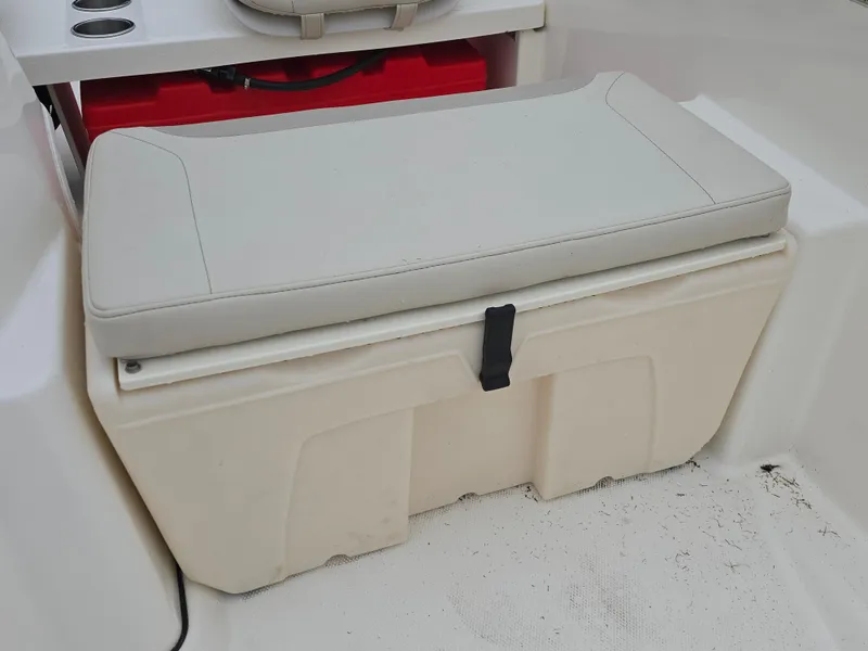 Slide: The Image of 2022 Boston Whaler 160 Super Sport seat with storage compartment. - 12