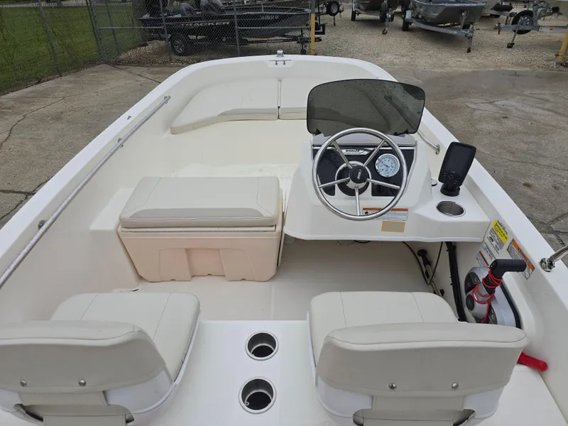 Slide: The Image of 2022 Boston Whaler 160 Super Sport boat interior with steering console and seating. - 14